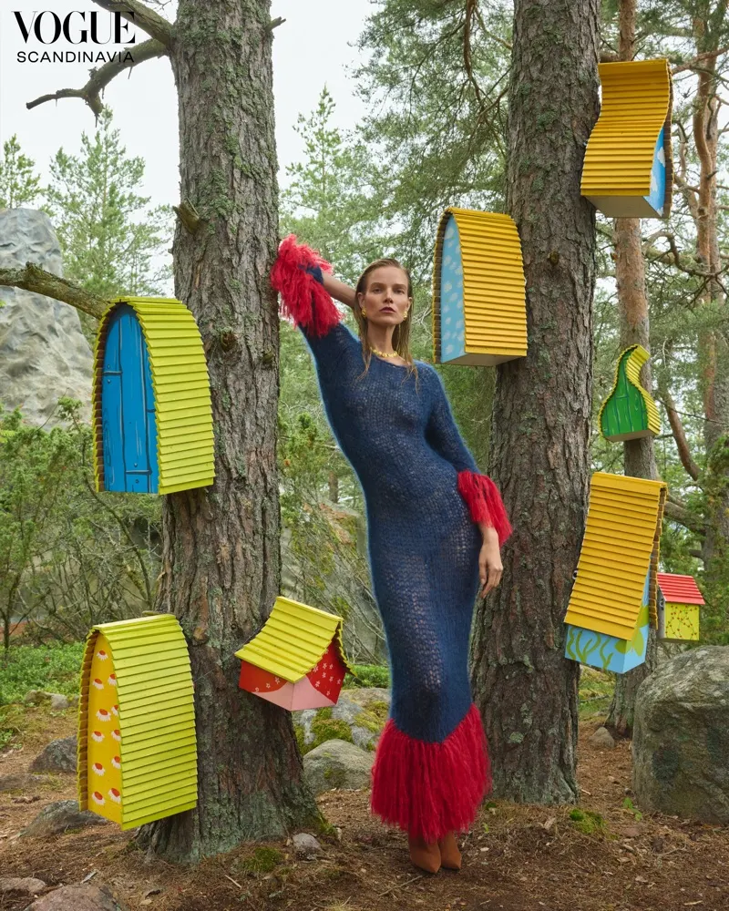 Suvi Riggs Koponen in sheer navy knit gown with crimson feathers for Vogue Scandinavia Moomins editorial