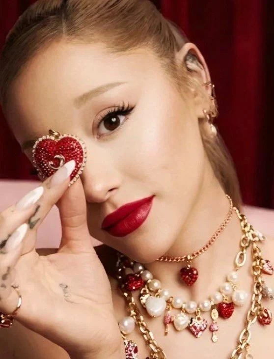 Ariana Grande showcases red strapless dress and heart-themed Swarovski jewelry in Valentine’s Day campaign