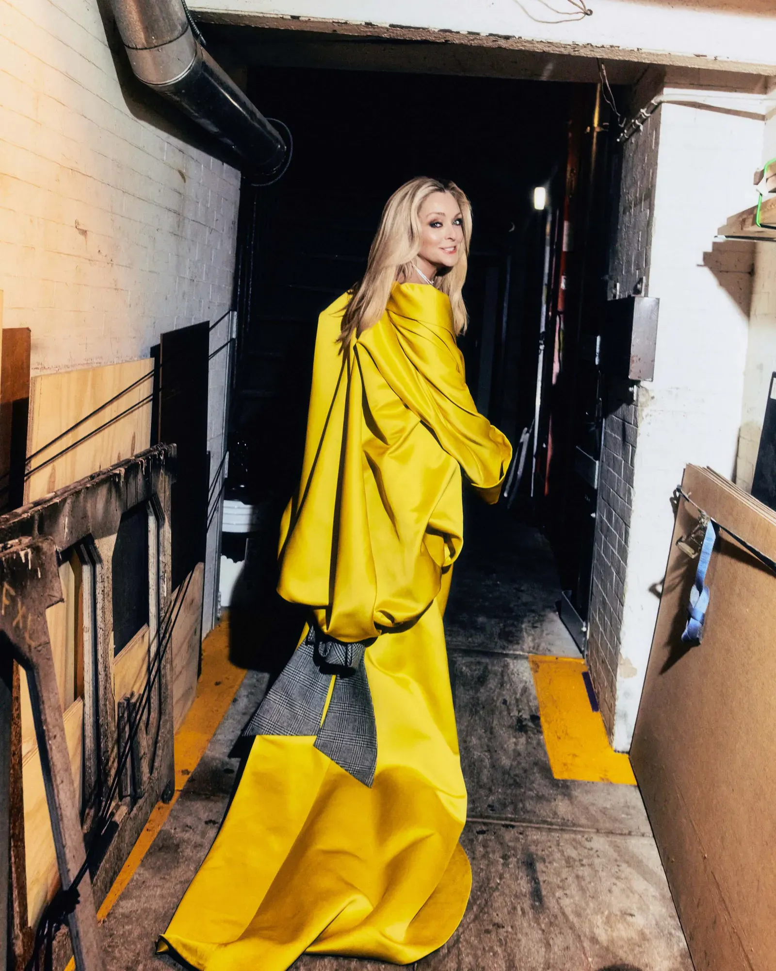 Jane Krakowski wearing a Bach Mai coat with a statement necklace for Vogue