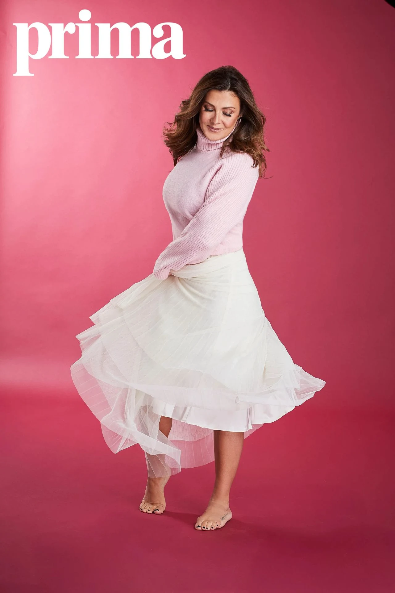 Kym Marsh in a light pink turtleneck and layered white skirt in Prima UK magazine