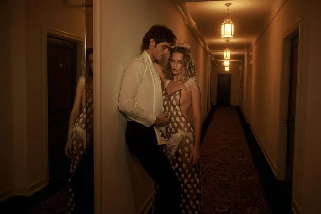 Jacob Elordi wears a Maison Margiela shirt, pants and scarf; Cartier earrings, bracelet and ring. Margot Robbie wears a Schiaparelli dress; Paspaley necklace.