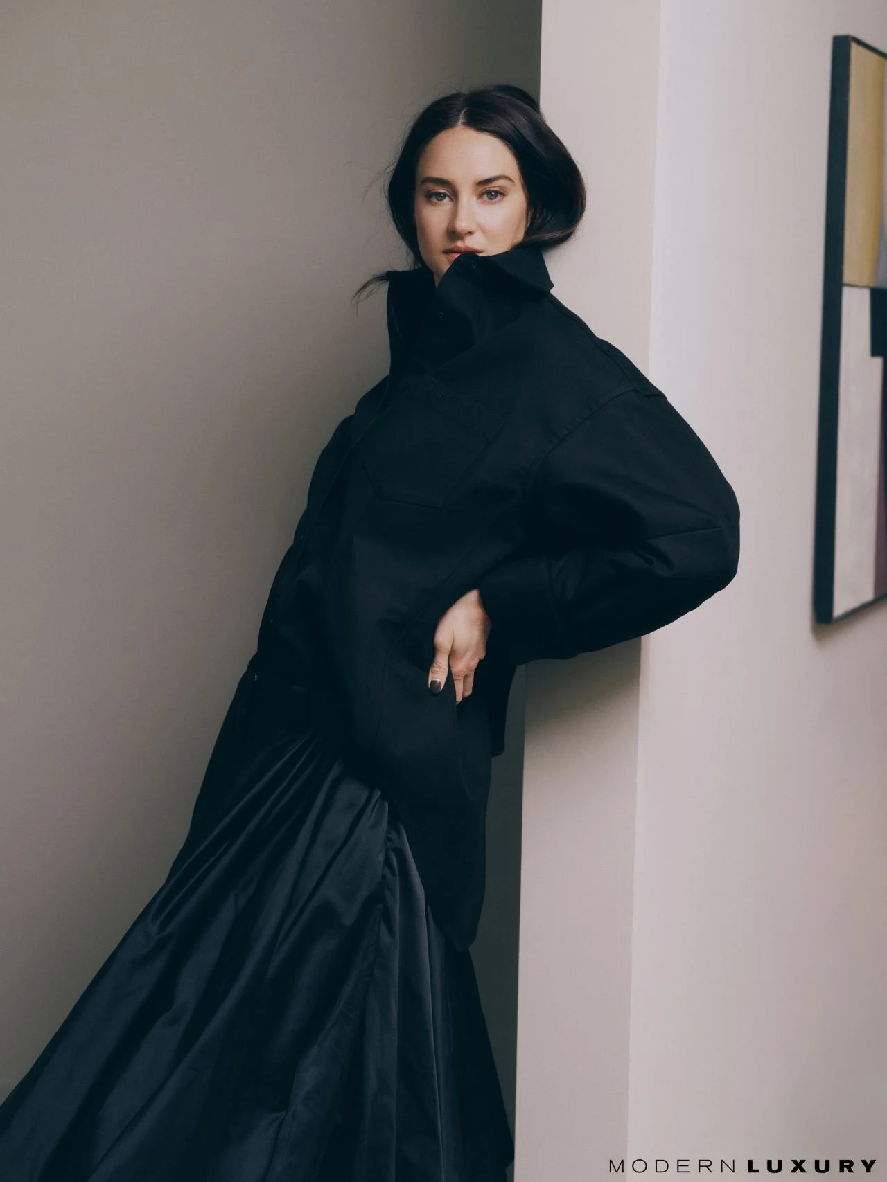 Shailene Woodley dramatically dressed in a black voluminous outfit during a photoshoot