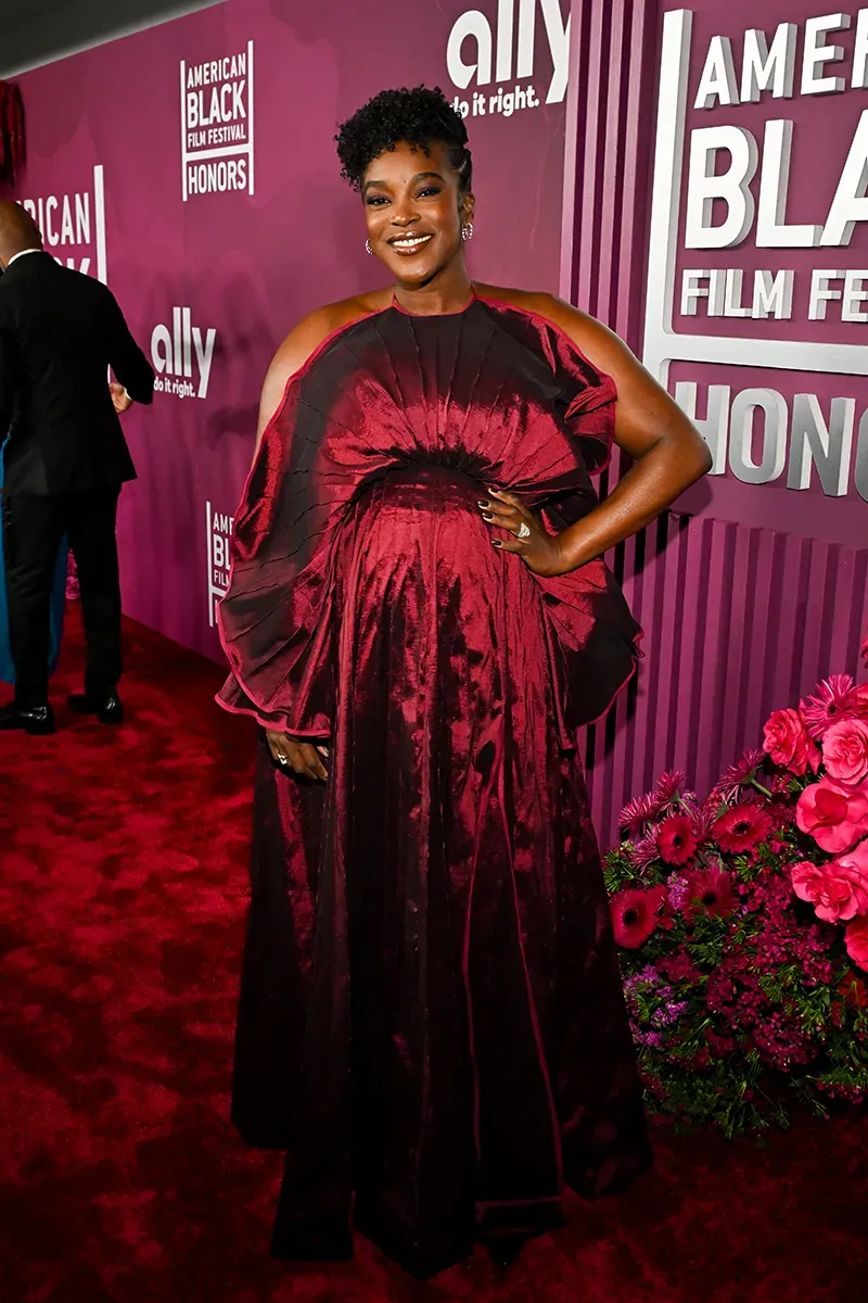 Wunmi Mosaku in a deep maroon off-the-shoulder gown at the ABFF Honors