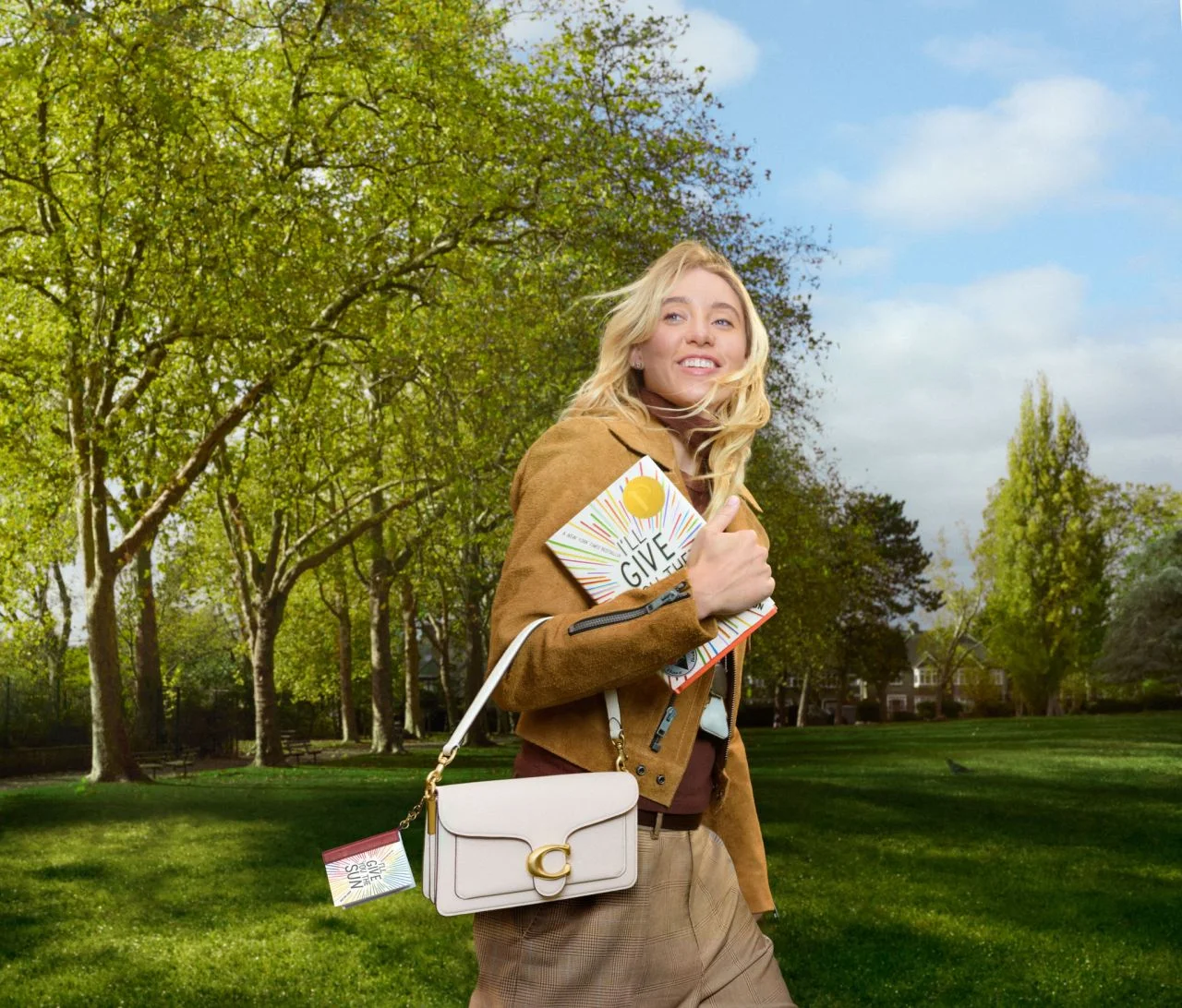 Paige Bueckers holding Coach Tabby with literary charm