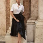 Deva Cassel wearing a white Dior blouse with black piping for Io Donna December 2025