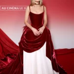 Margot Robbie posing on the red carpet in a corseted Chanel gown and champagne diamond choker